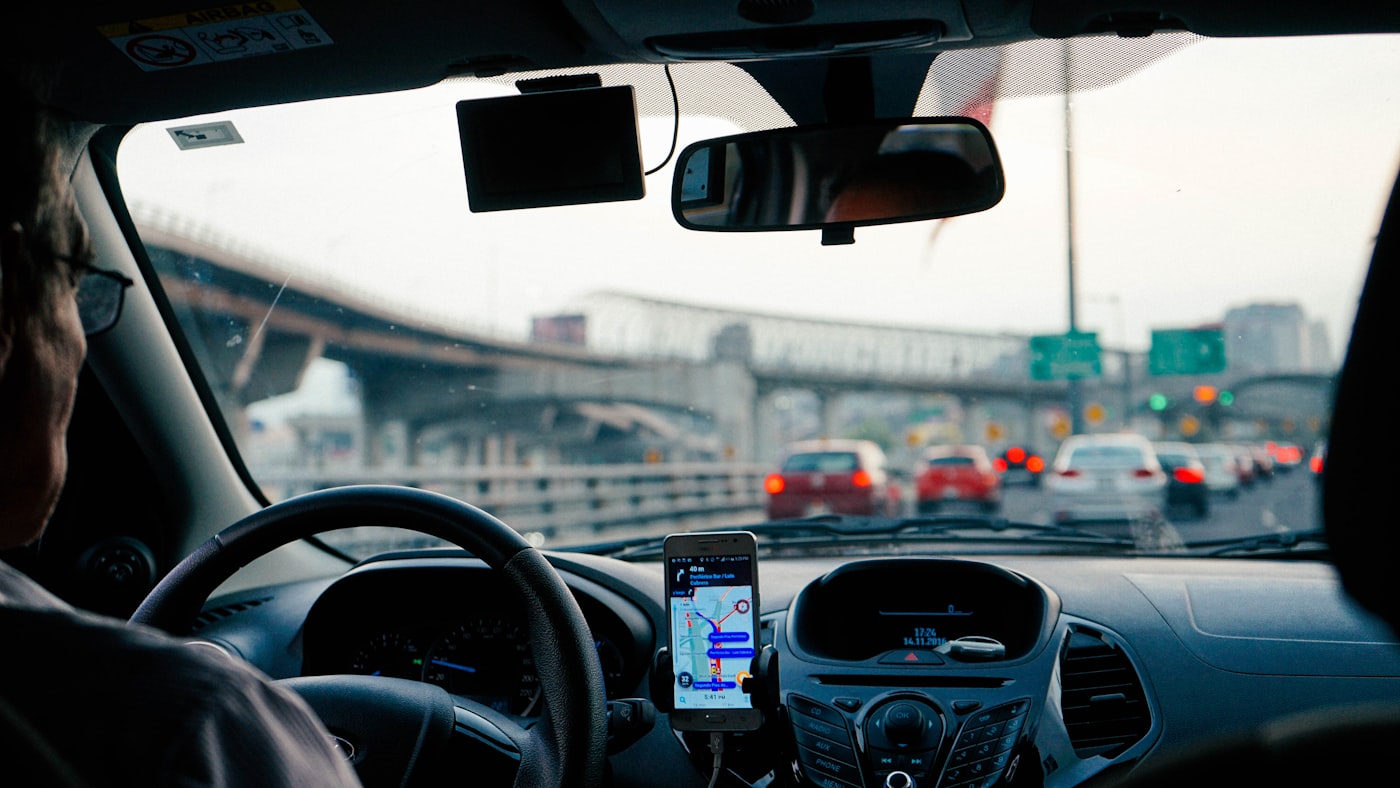Male driver navigating with GPS on a long city ride