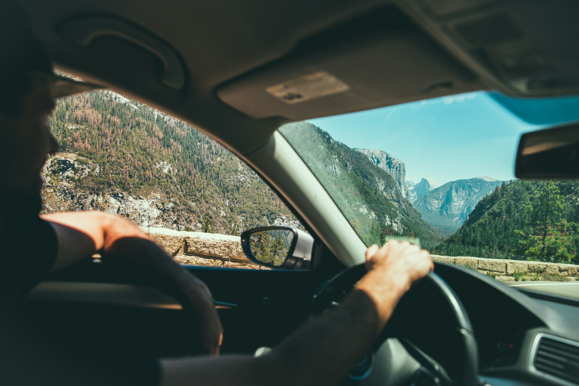 Smiling male driver on a scenic sightseeing road